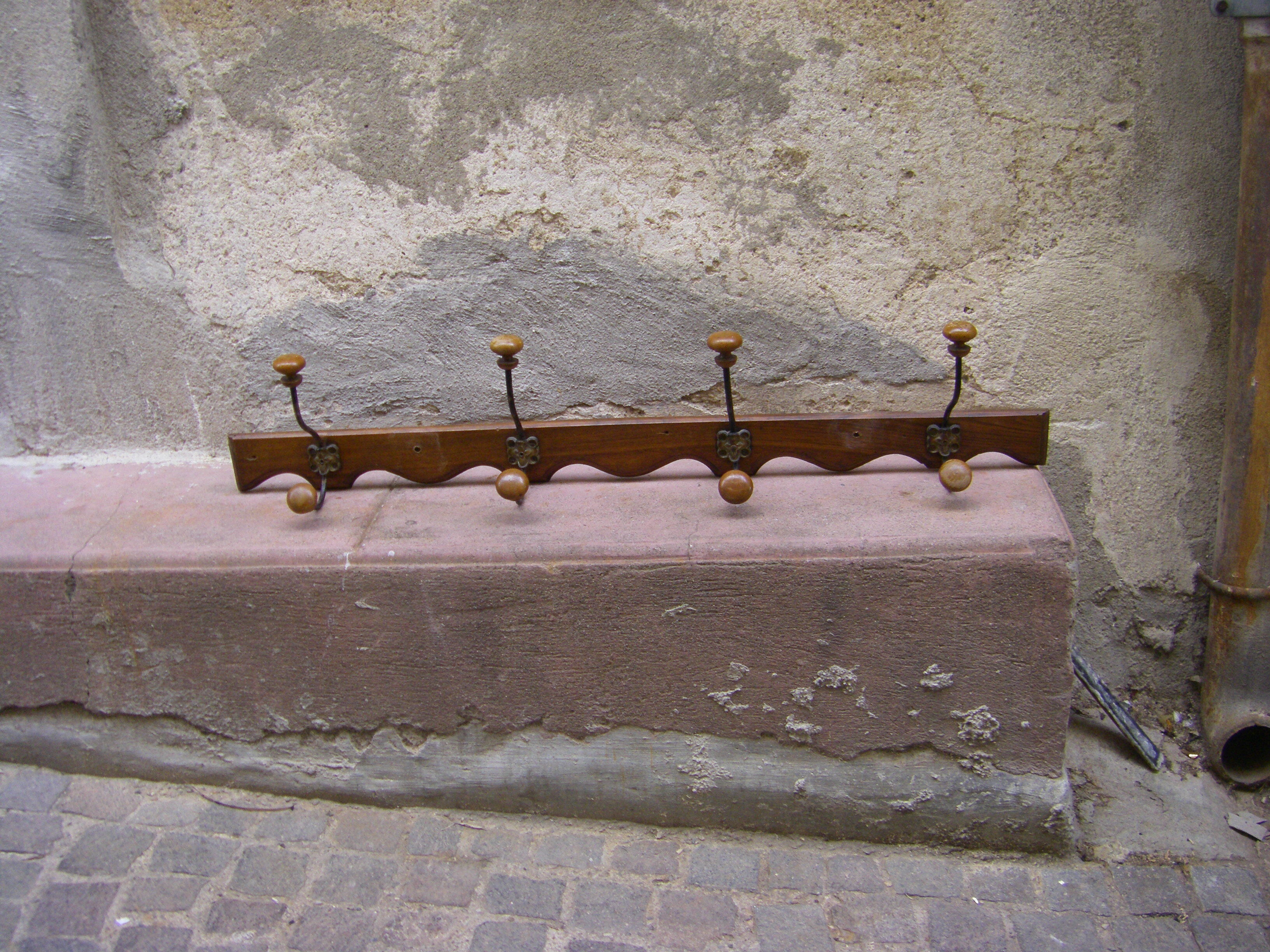 Wall coat rack has four hooks