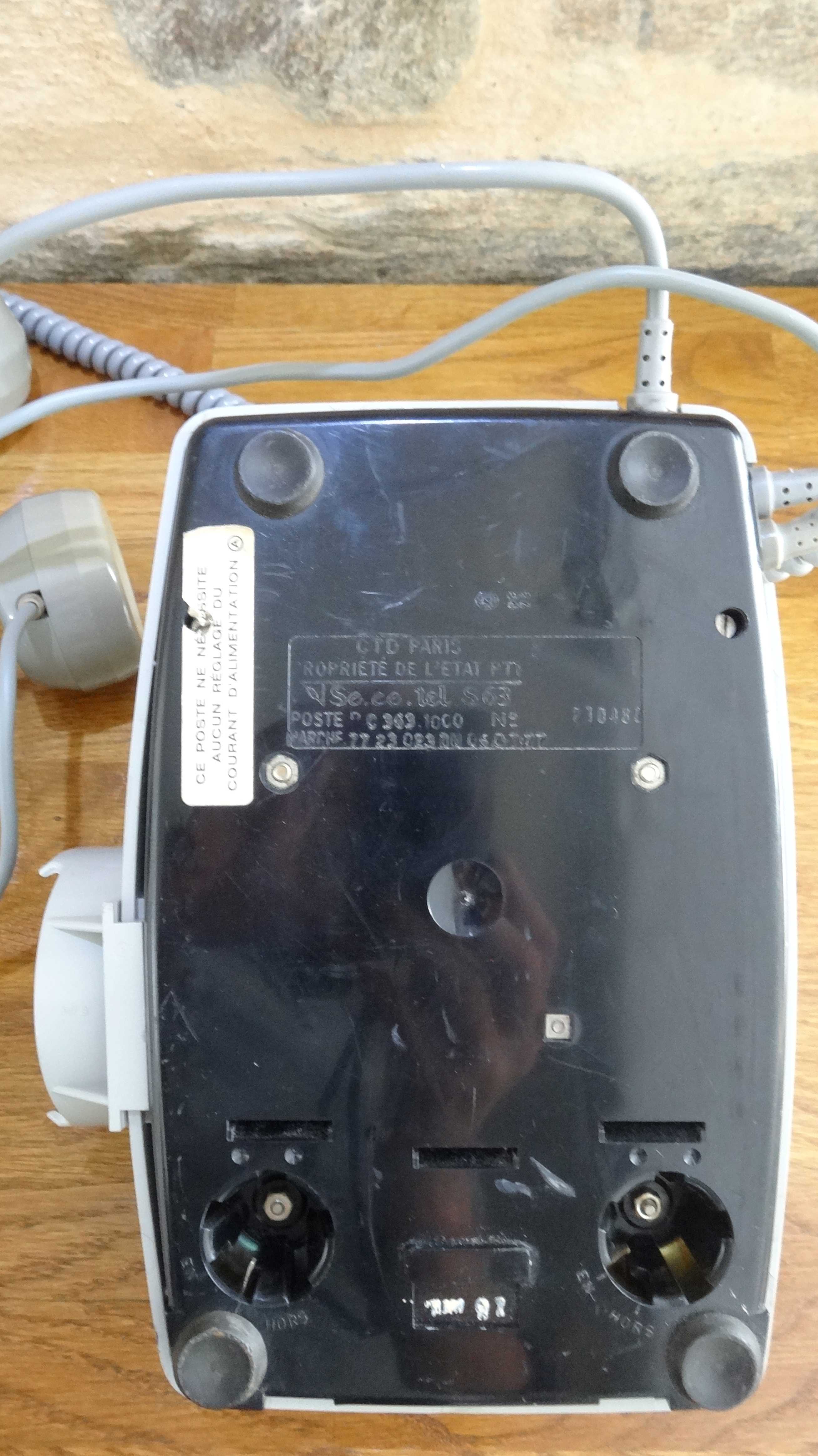 Grey vintage rotary dial phone with earpiece