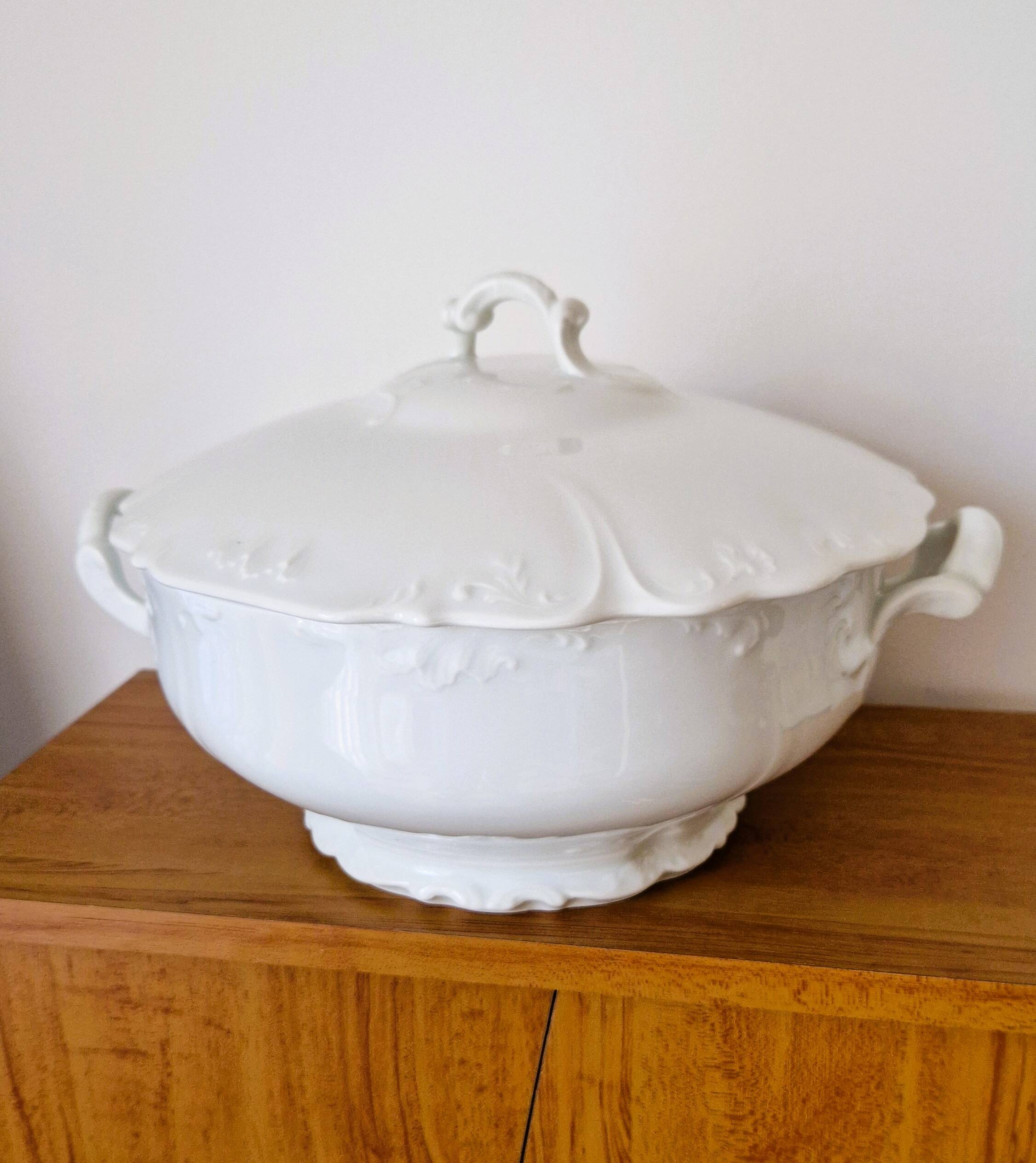 White porcelain soup tureen from Limoges with a vegetal scroll design.