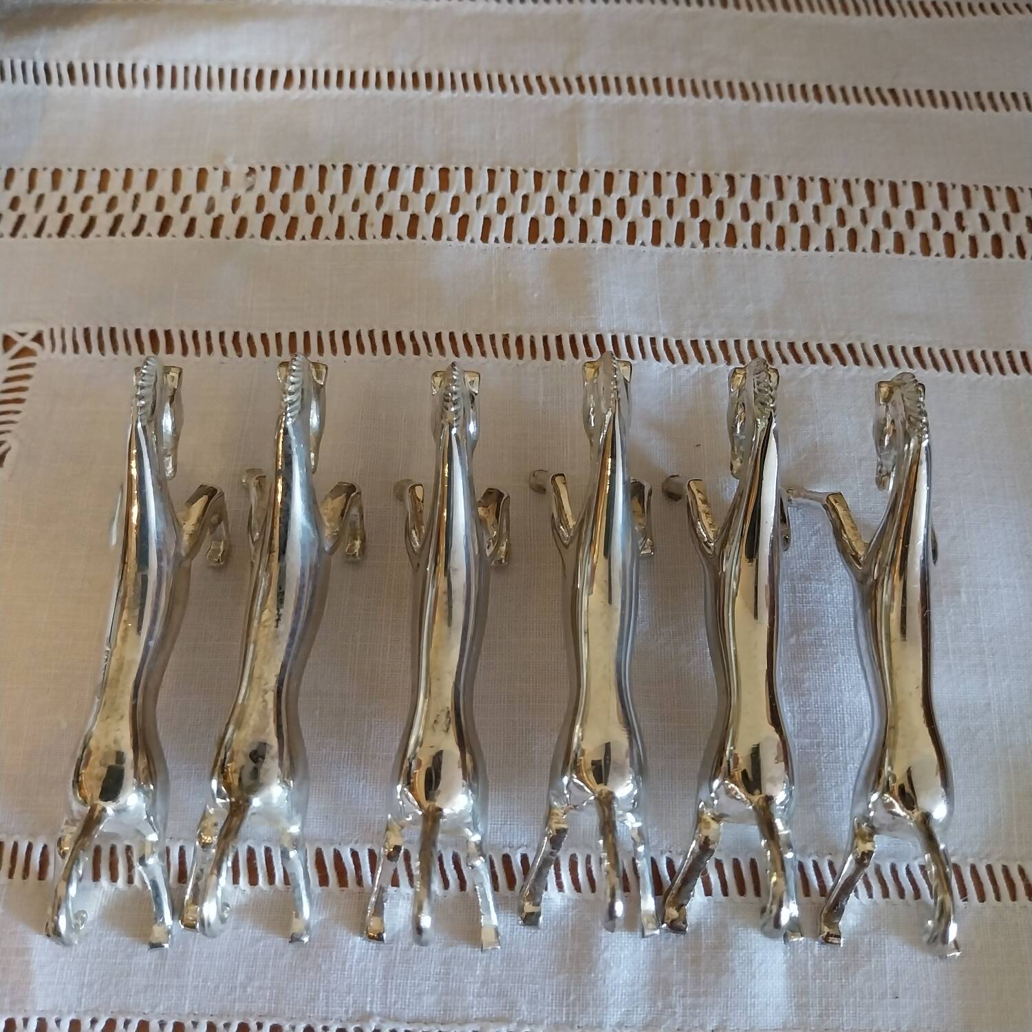 Silver metal horse-shaped knife rests