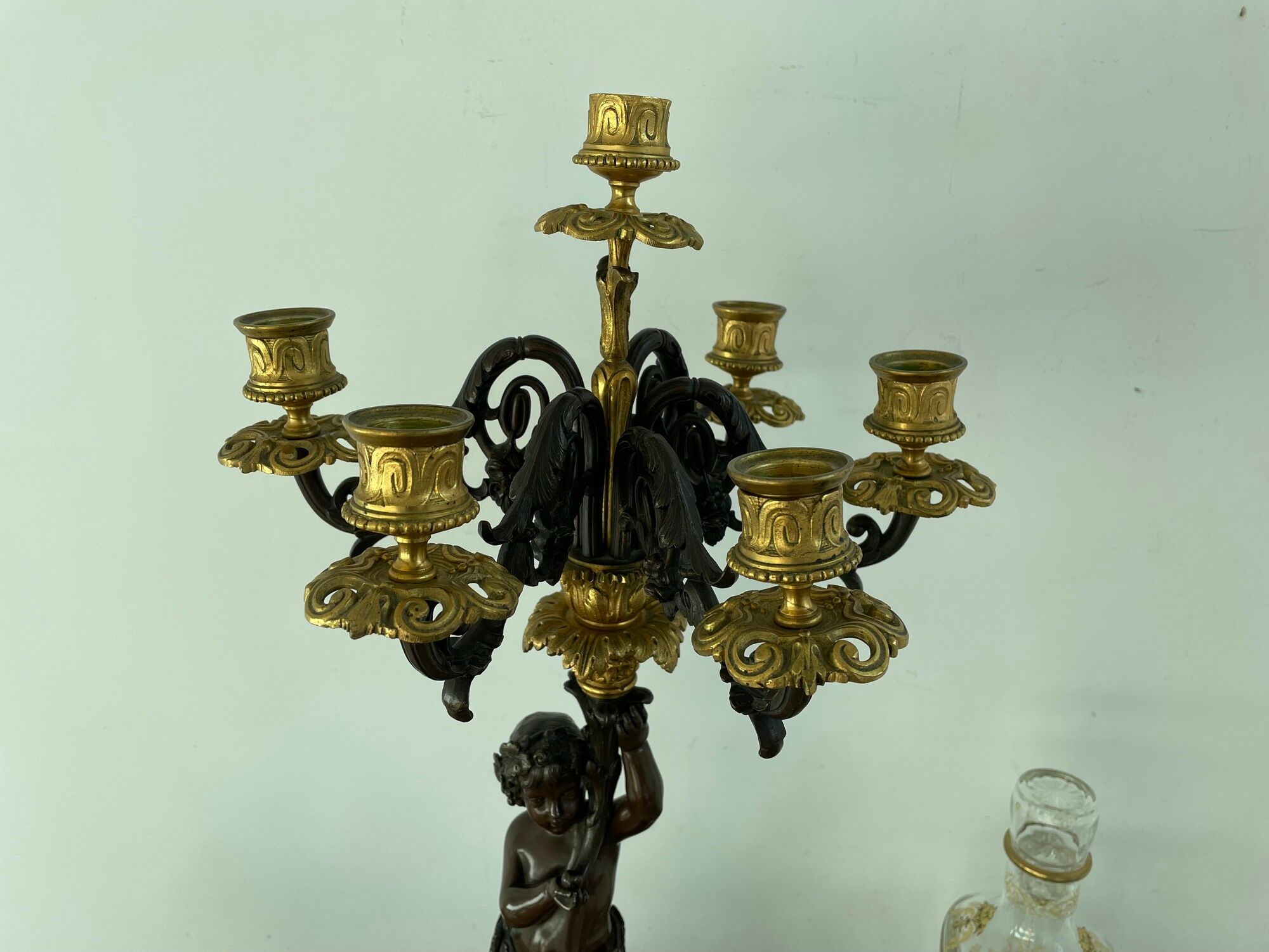 Candelabra with cherub in patinated bronze