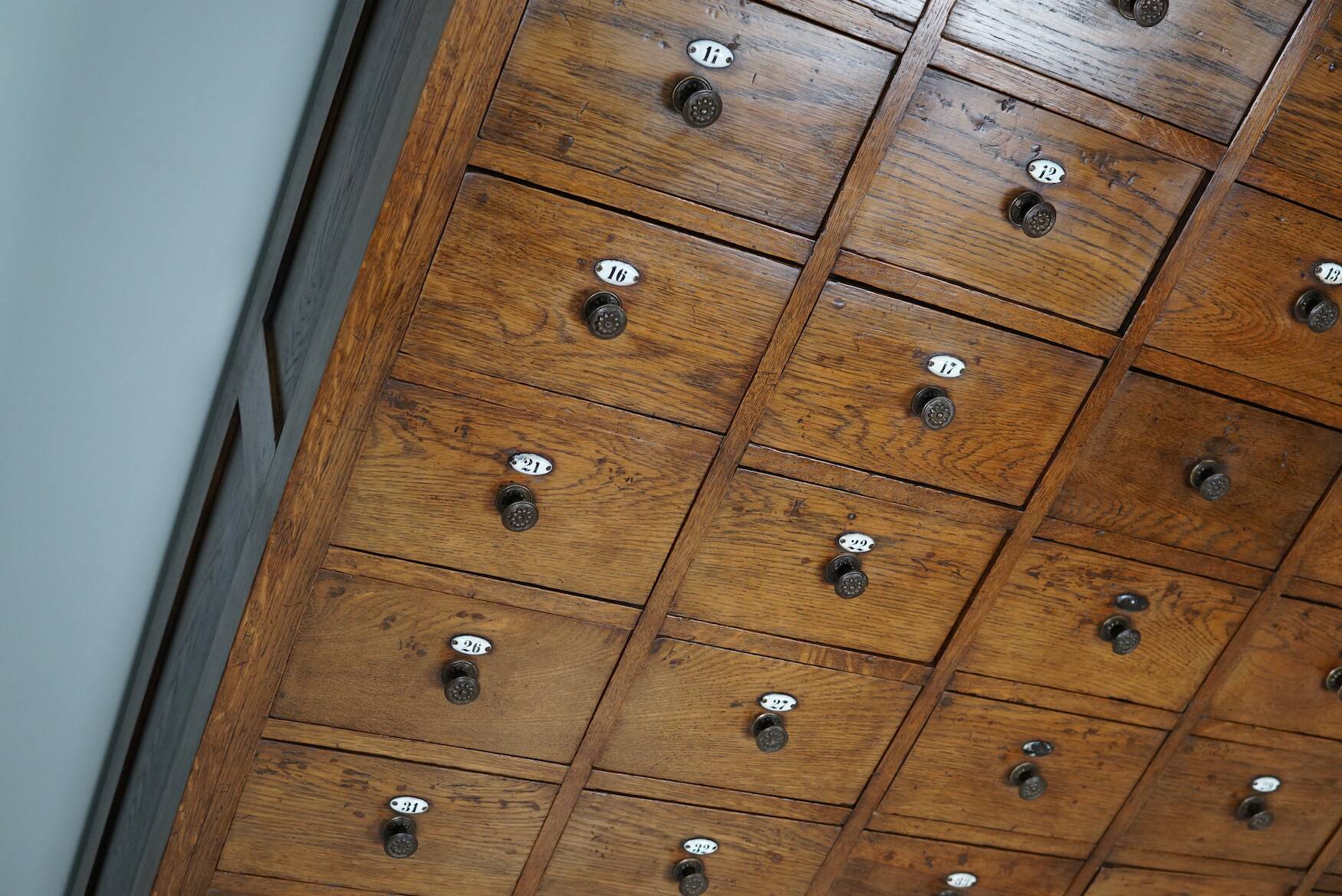 Large dutch oak apothecary cabinet / barber cabinet with enamel shields, 1900s