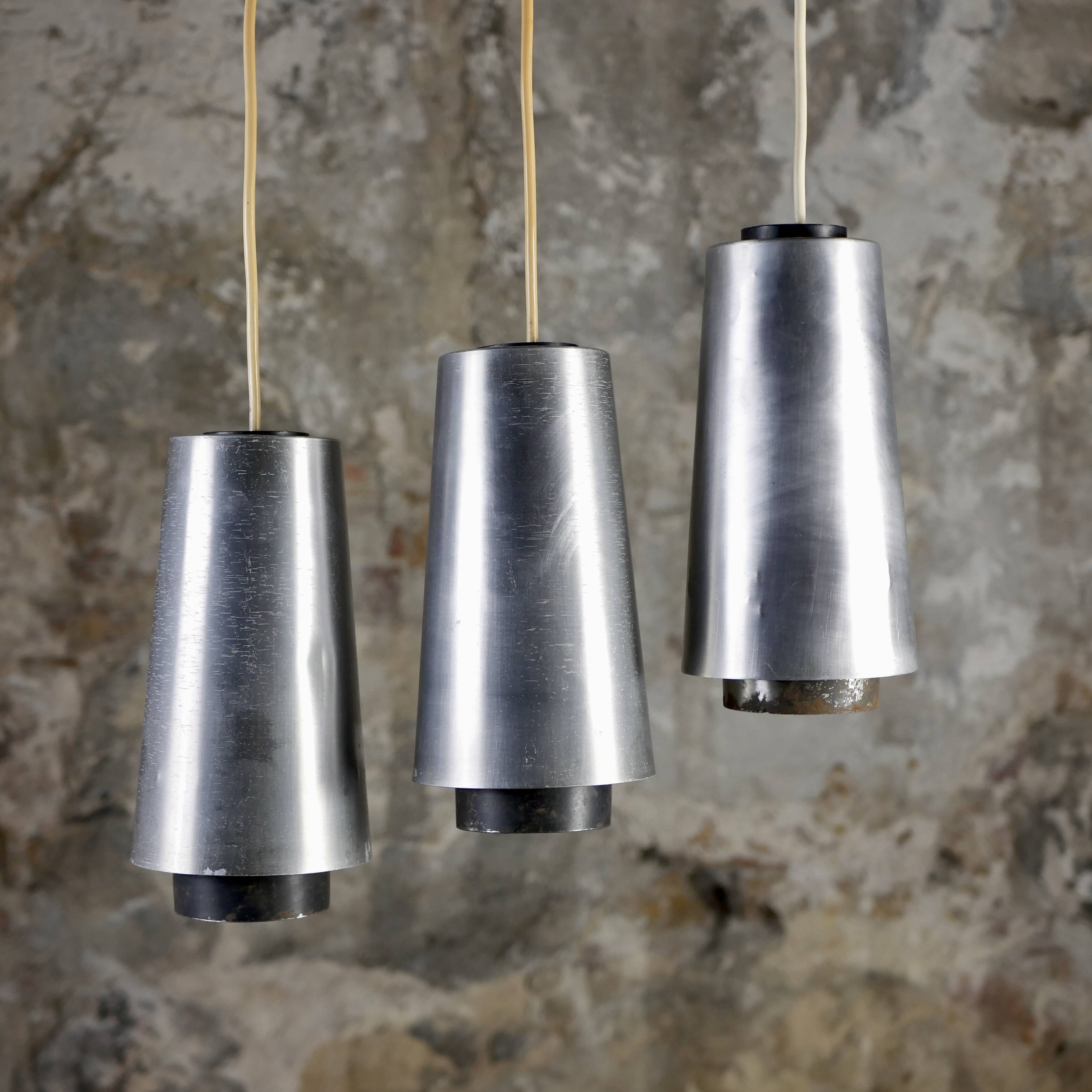 Trio of Raak steel pendant lights, 1960s