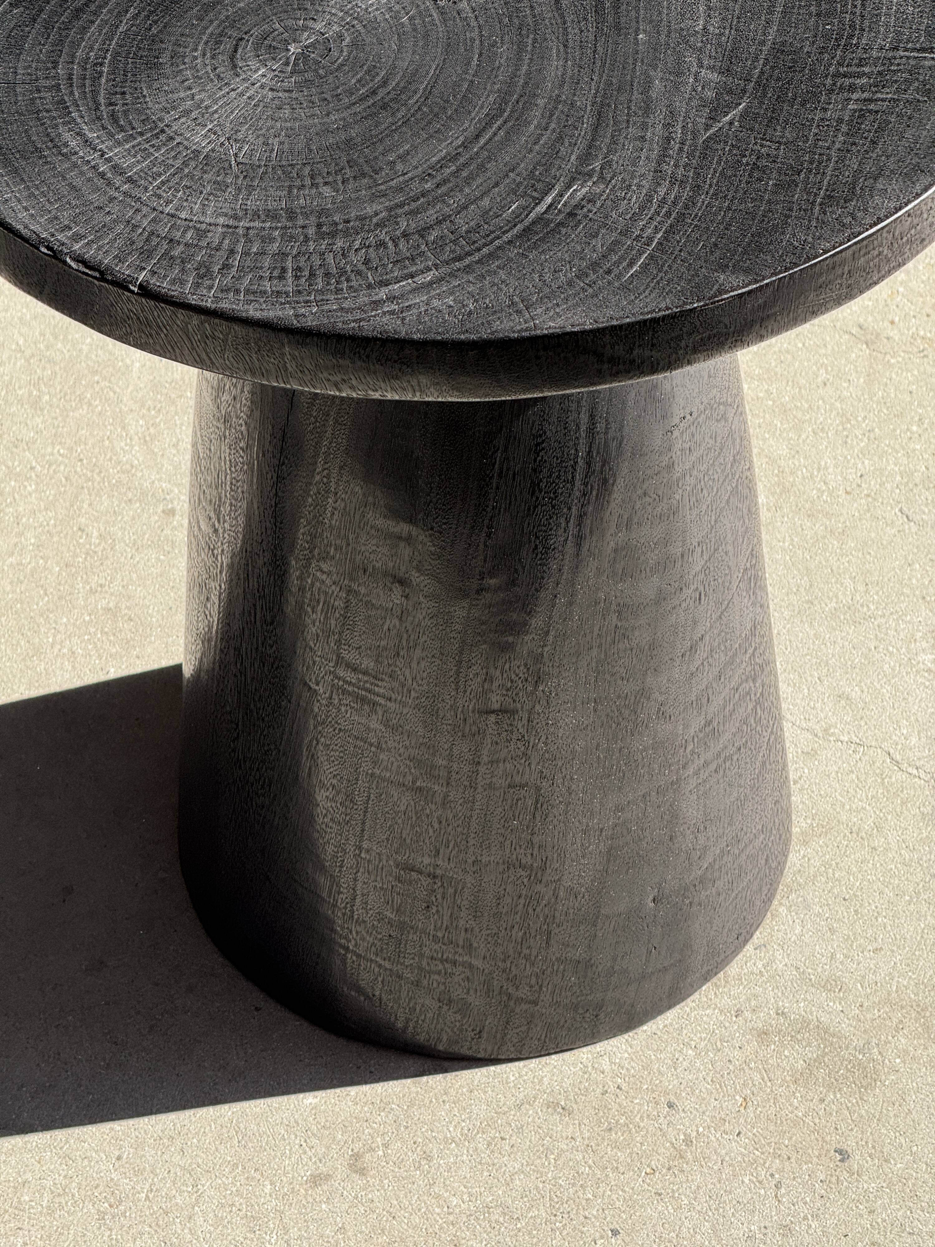 Black solid mango side table (monoxyle) with conical legs