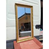 Wooden mirror and gold trim