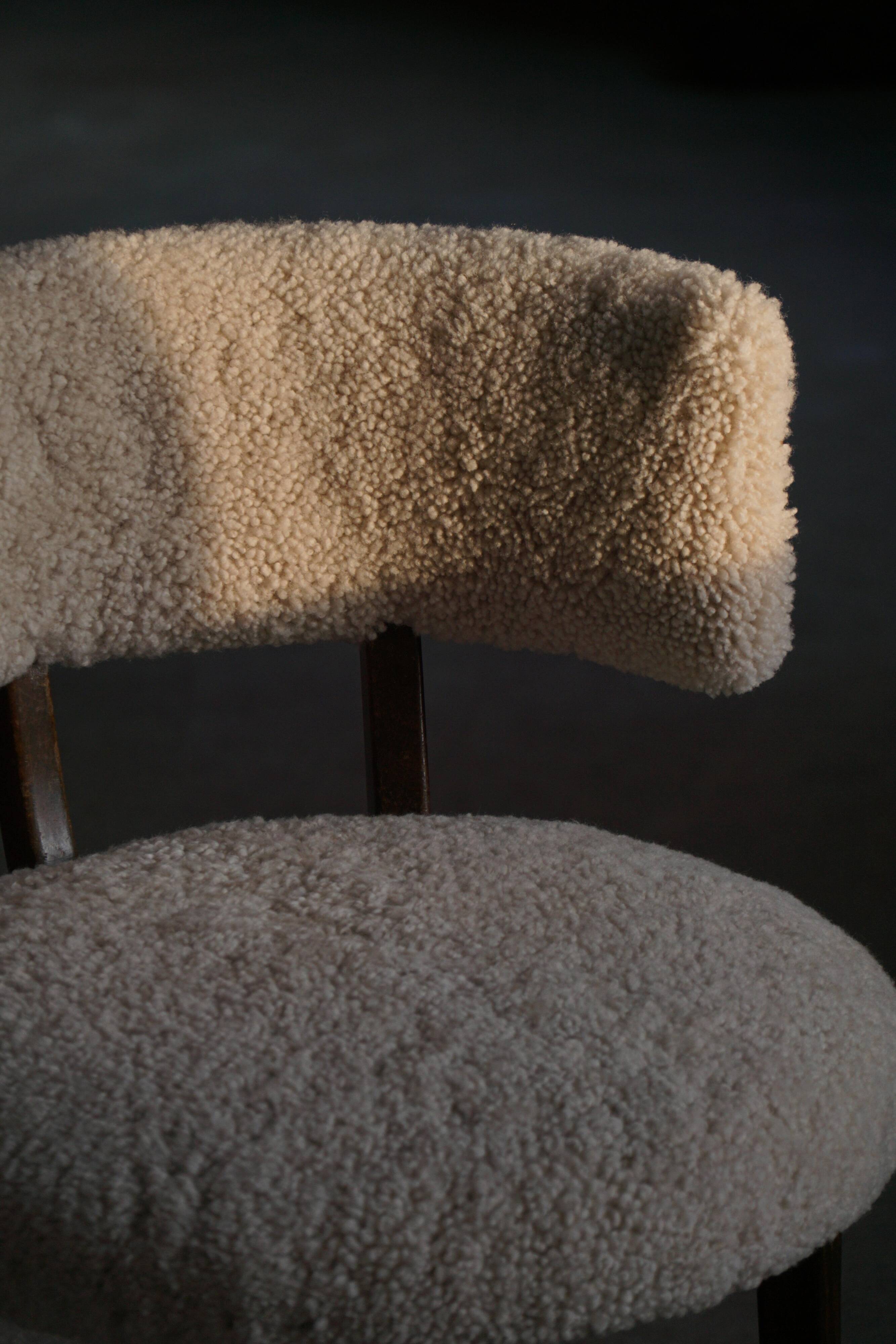 A modern Danish elegant low-back chair, reupholstered in lambswool, 1940s.