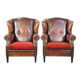 Set of 2 sheep leather wingback chairs with red corduroy seat cushions