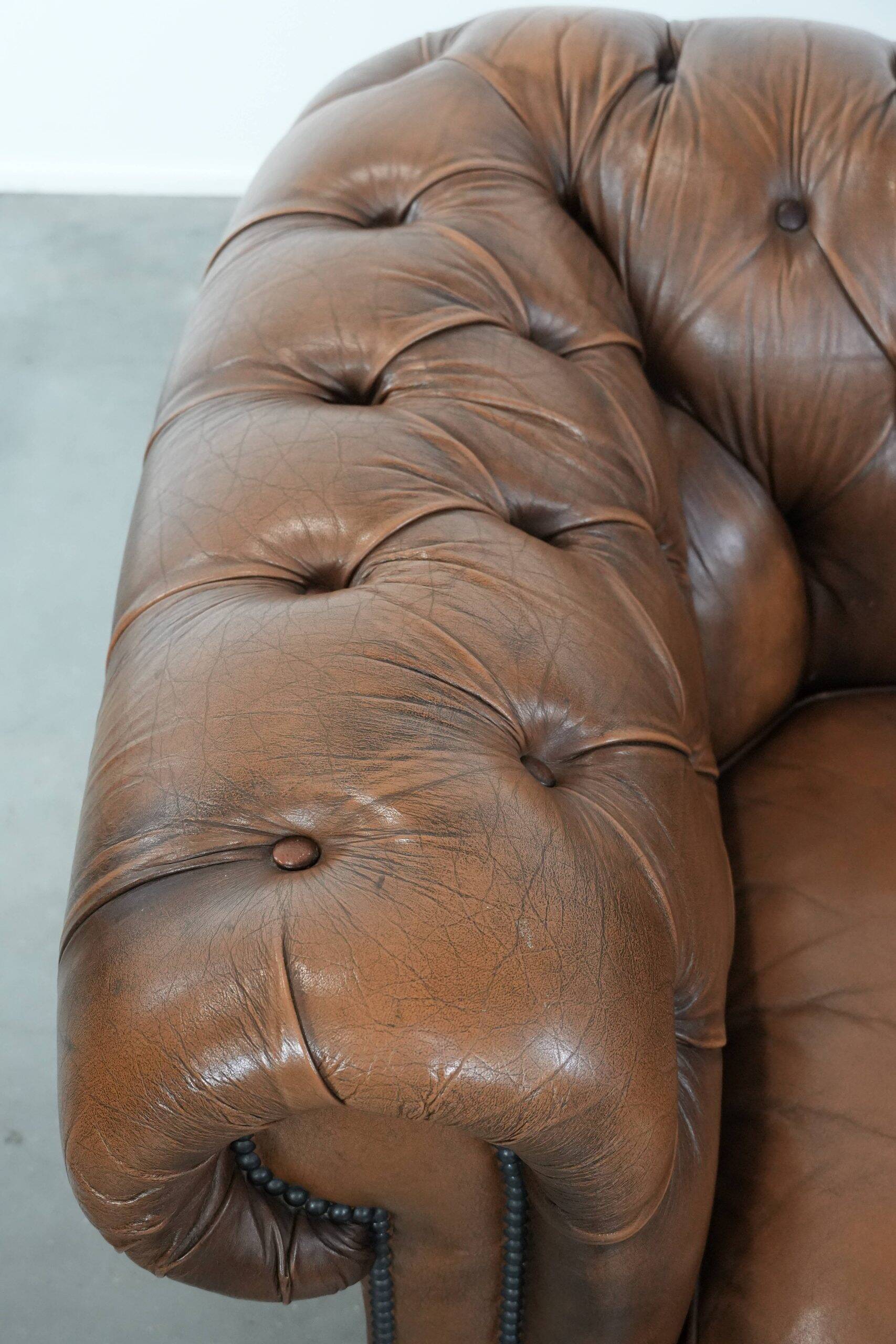 Brown cowhide leather chesterfield armchair  in English style on wheels