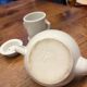 Antique white earthenware teapot, individual service with filter.