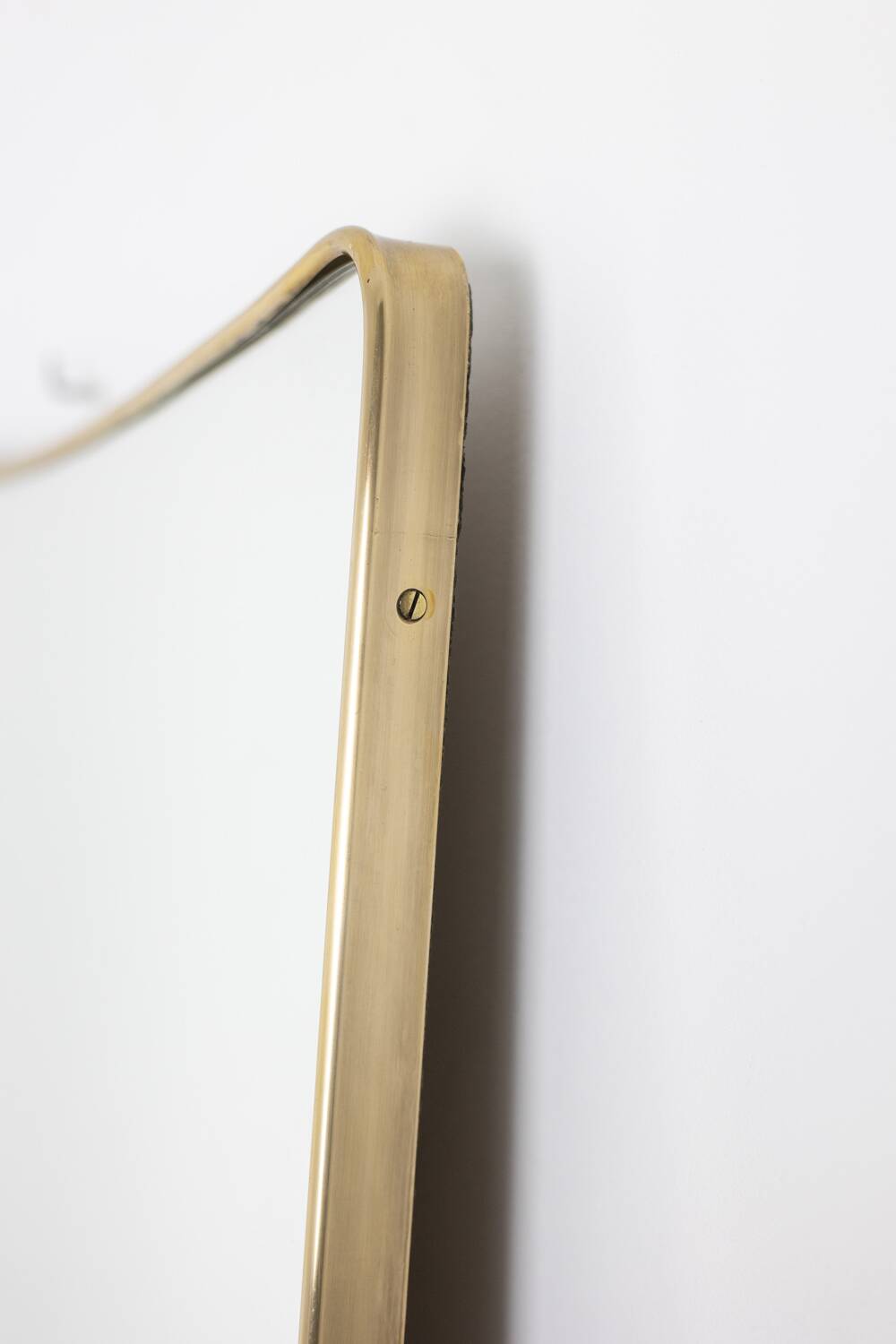 Pair of narrow gilt brass mirrors. Circa 1970.