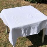 Old square table in damask cotton palm floral pattern