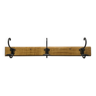 Antique wooden coat rack with metal hooks