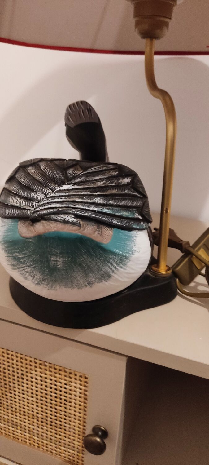 Decorative table lamp with a sculpted duck-shaped base and painted finish.