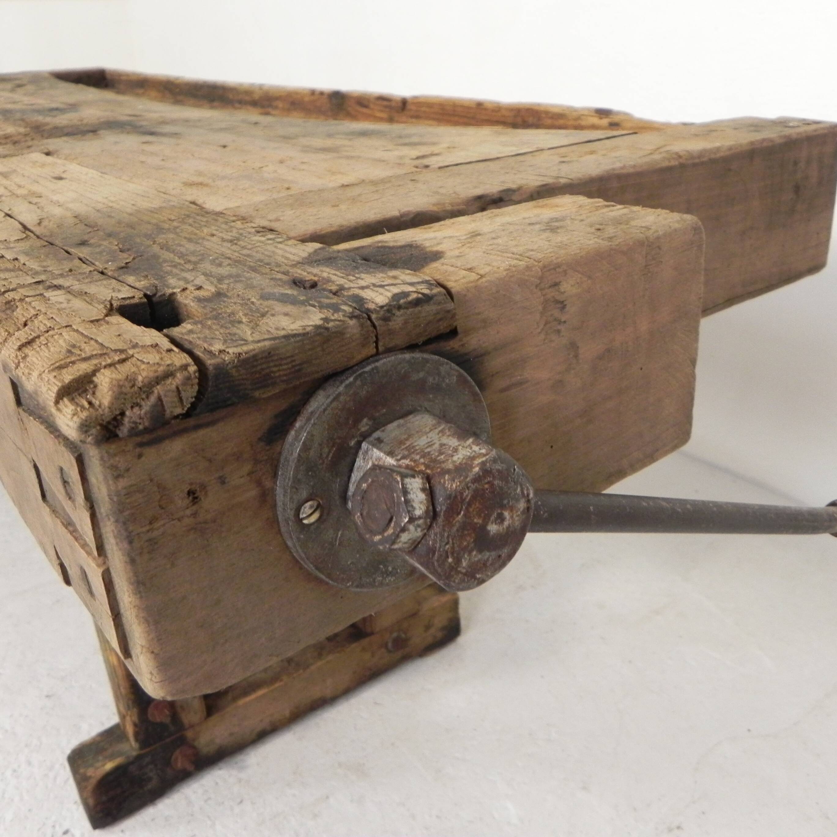Wooden industrial workbench with vice, 194 cm long, 1930s.