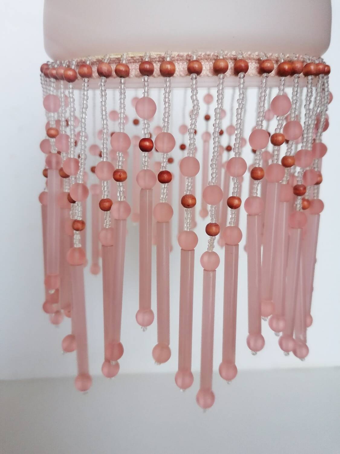Pink glass wall lamp with garland of pearls