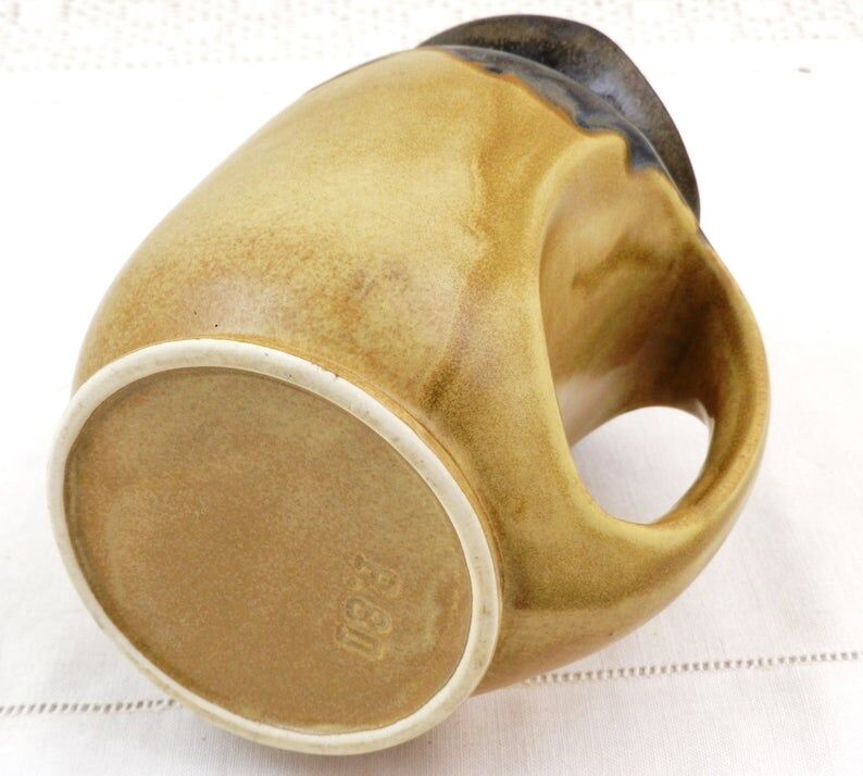 Vintage art deco water pitcher with drippy dark blue glaze.