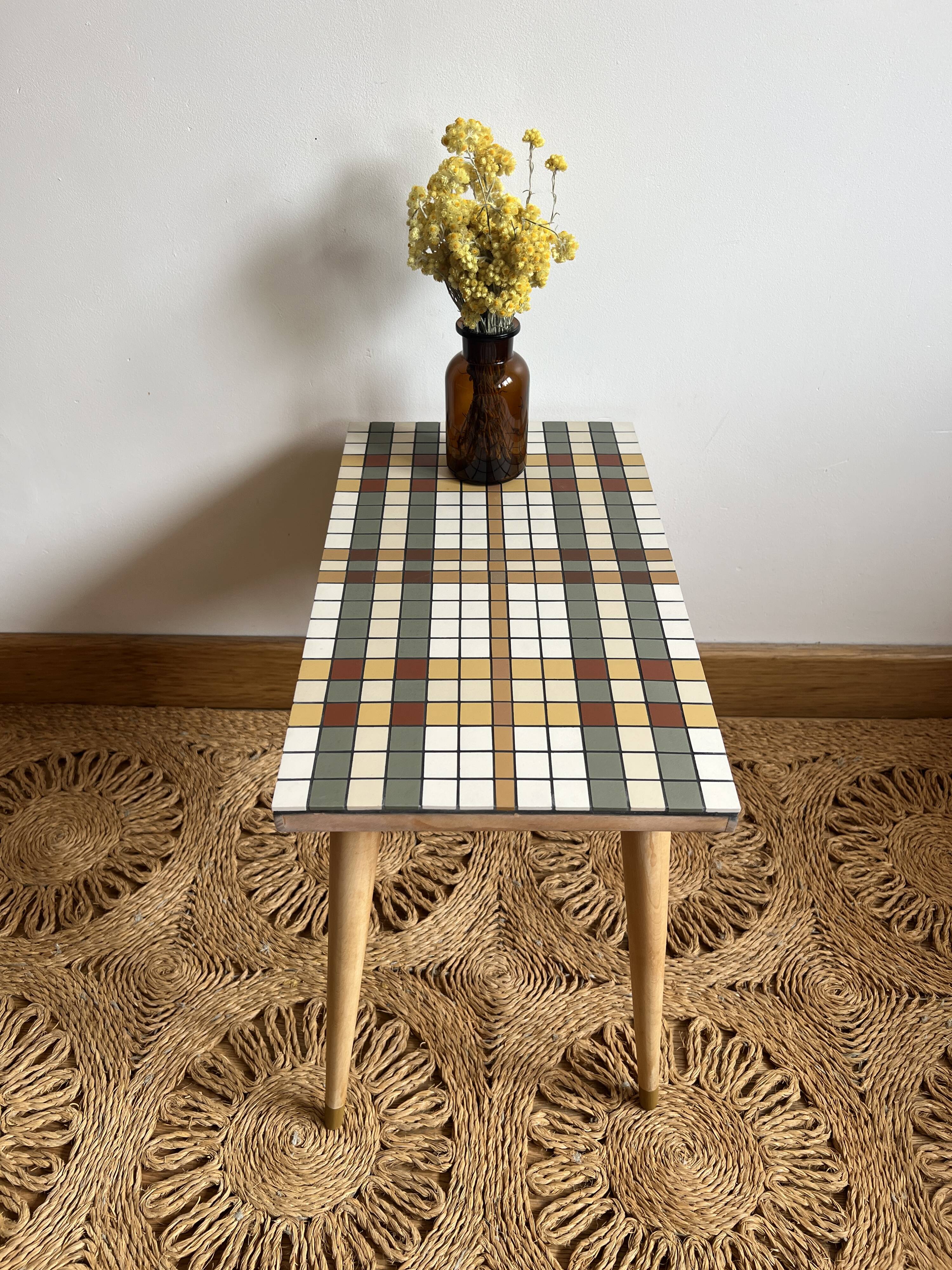 Small mosaic bedside table with tapered legs.