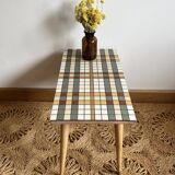 Small mosaic bedside table with tapered legs.