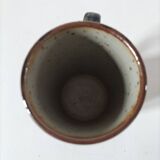 Glazed stoneware mug with free decoration, vintage pottery work.