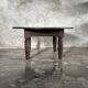 Antique round coffee table in Indonesian teak with turned legs.