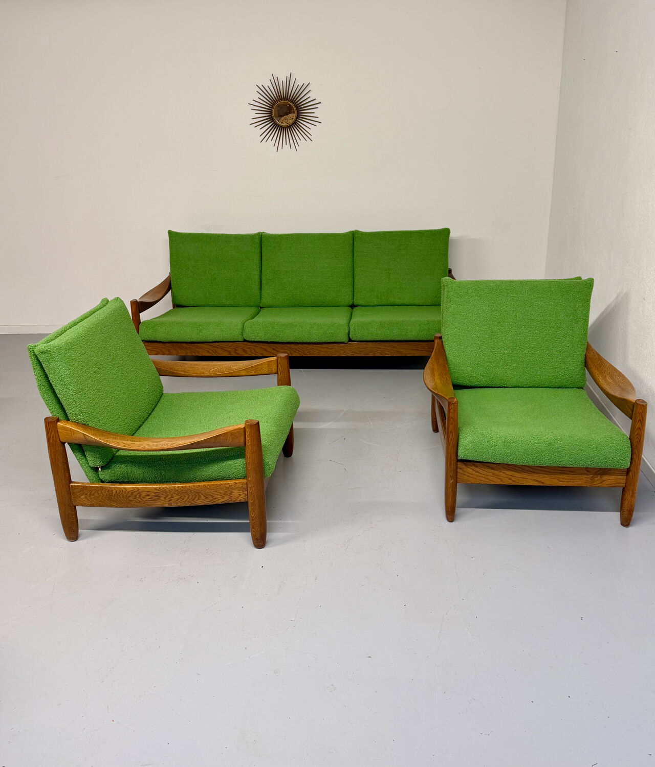 Living room sofa and Scandinavian design armchairs from the 1960s in green boucle.