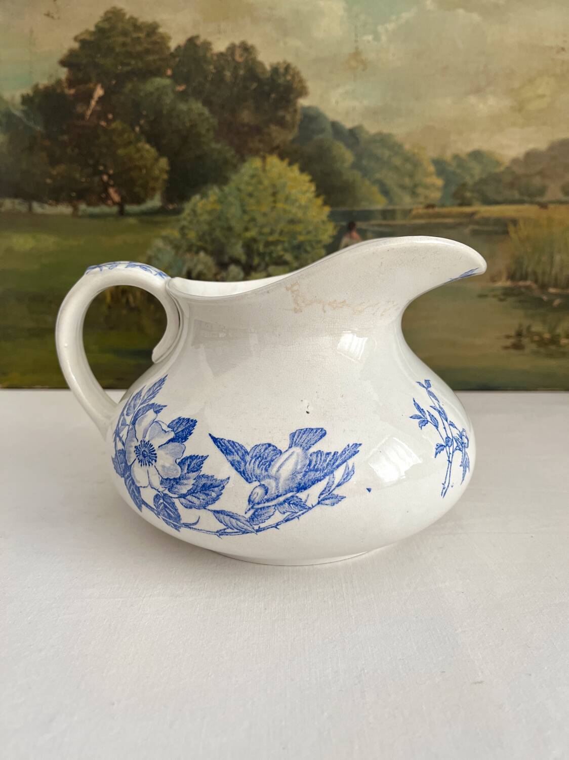 Antique chubby ironstone jug with floral and bird decoration