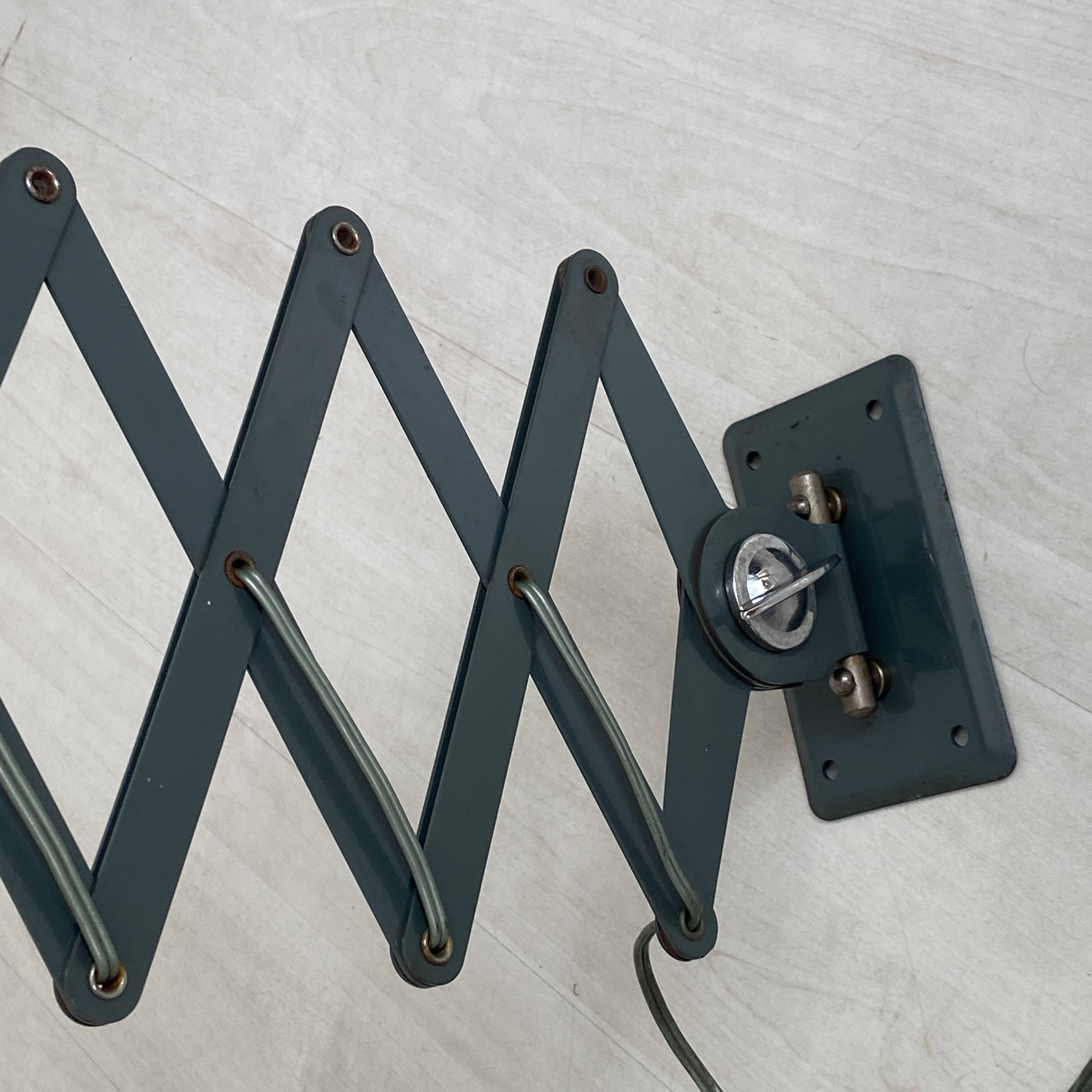 Vintage 1950s green lacquered sheet metal workshop wall light with accordion arm.