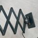 Vintage 1950s green lacquered sheet metal workshop wall light with accordion arm.
