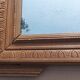 Louis XVI mirror in carved wood, 19th century.