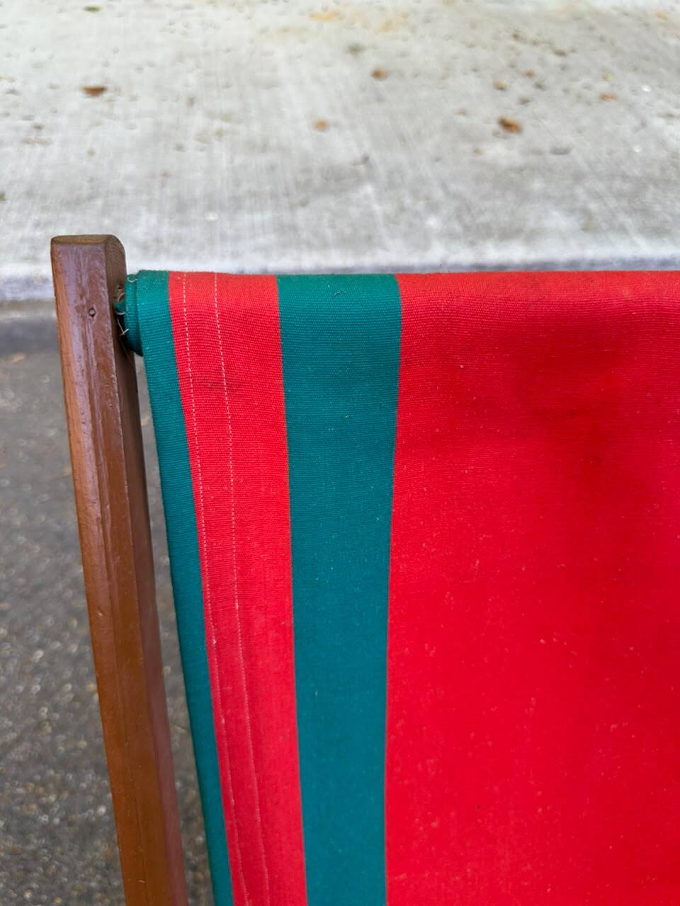 Vintage folding wooden deck chair with red and green striped canvas from the 1970s.