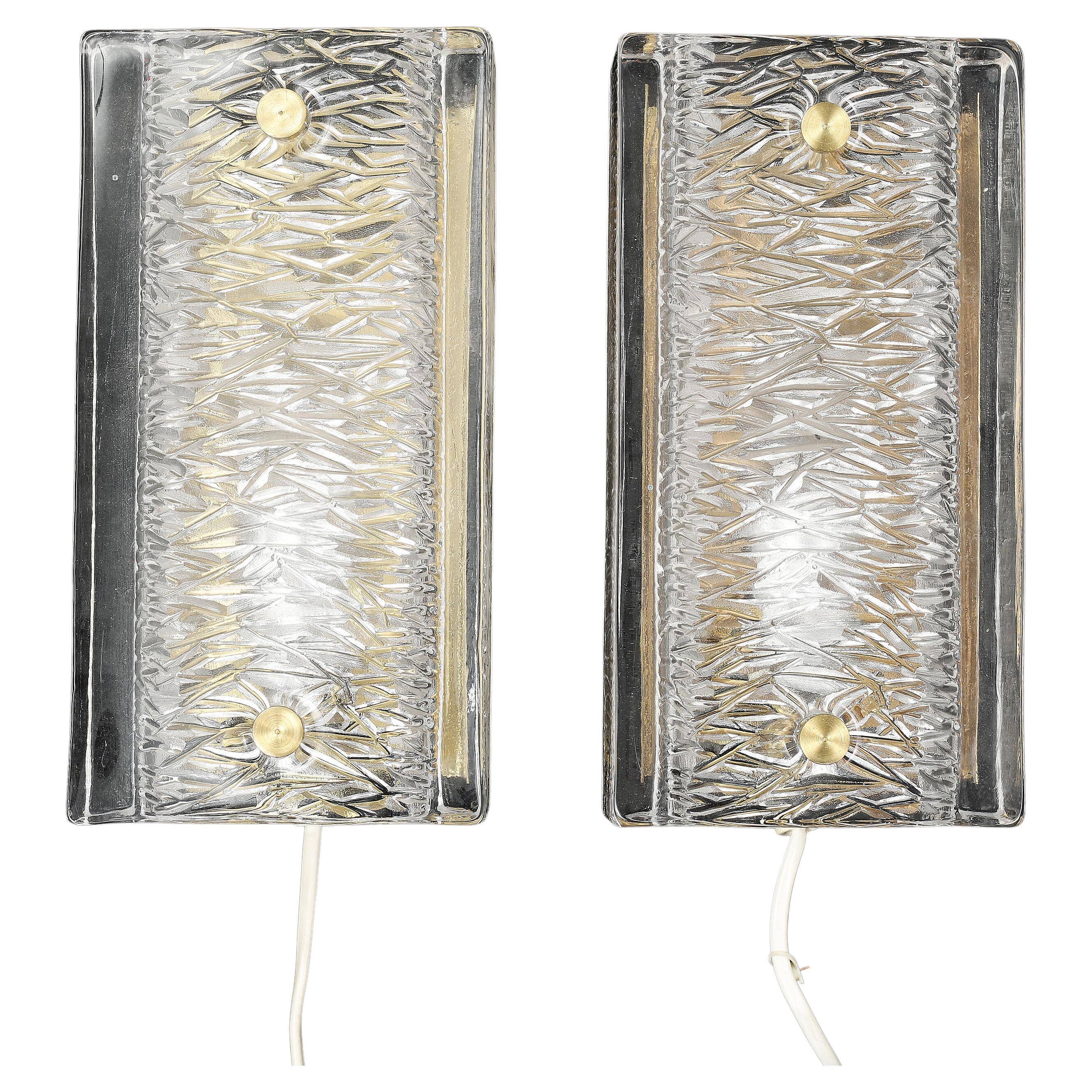 Pair of Orrefors wall lights in cast glass and brass, Sweden 1960.