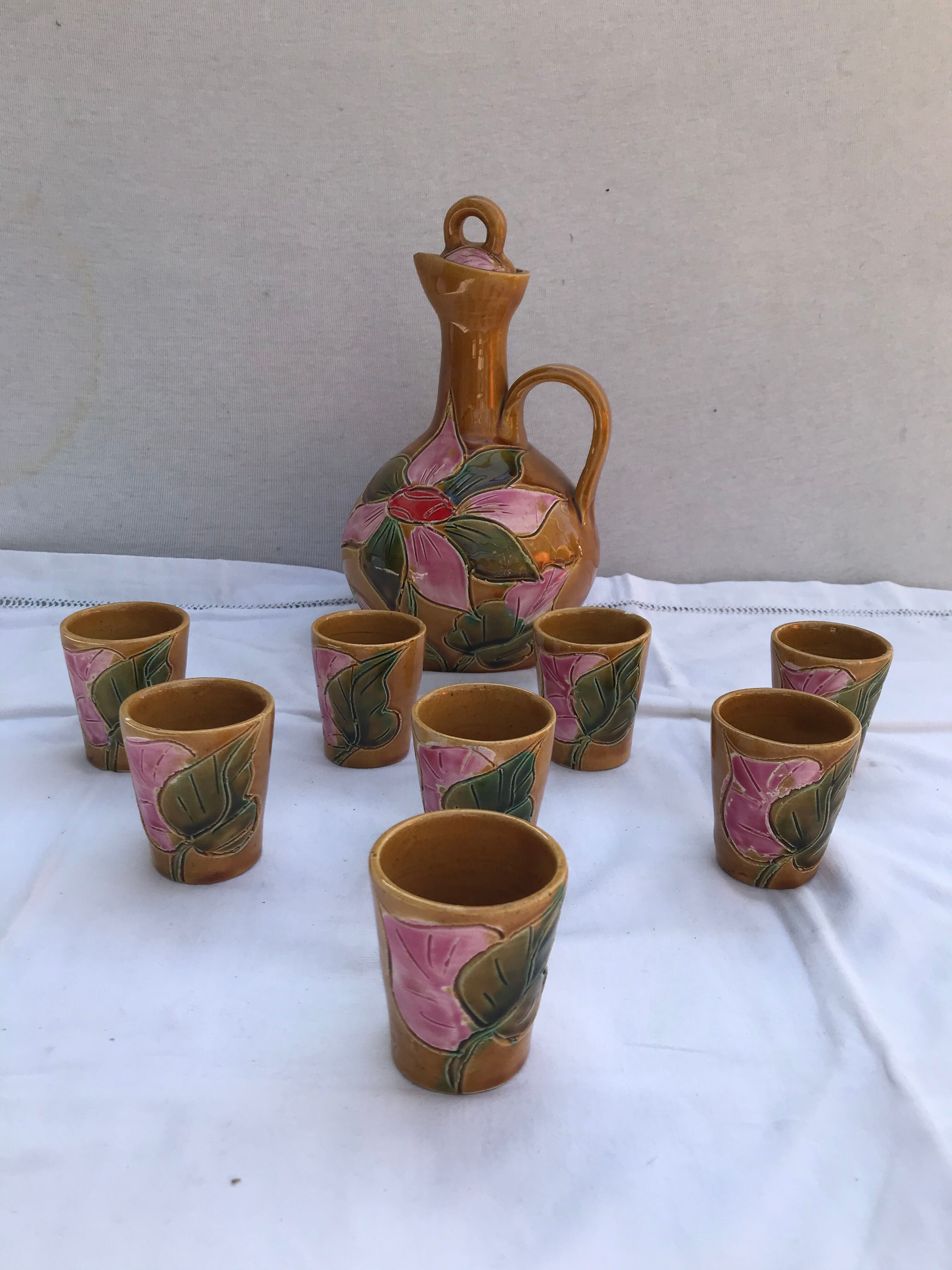 Old carafe with 8 ceramic glasses