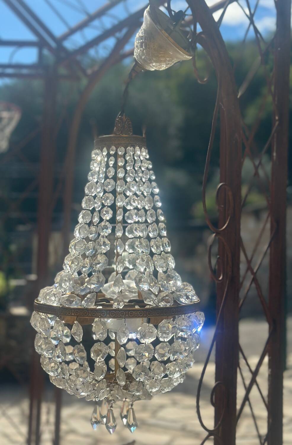 Basket chandelier with crystal and gilded brass pendants, circa 1930.
