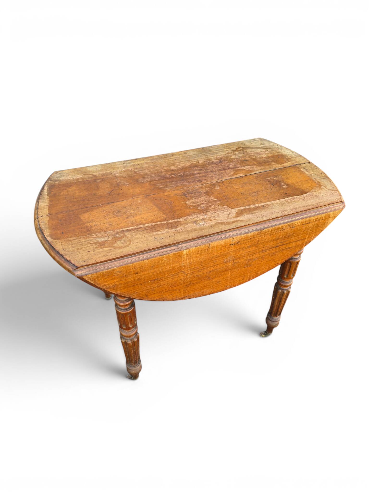 Antique drop-leaf table in wood, with turned legs and castors.