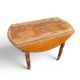 Antique drop-leaf table in wood, with turned legs and castors.