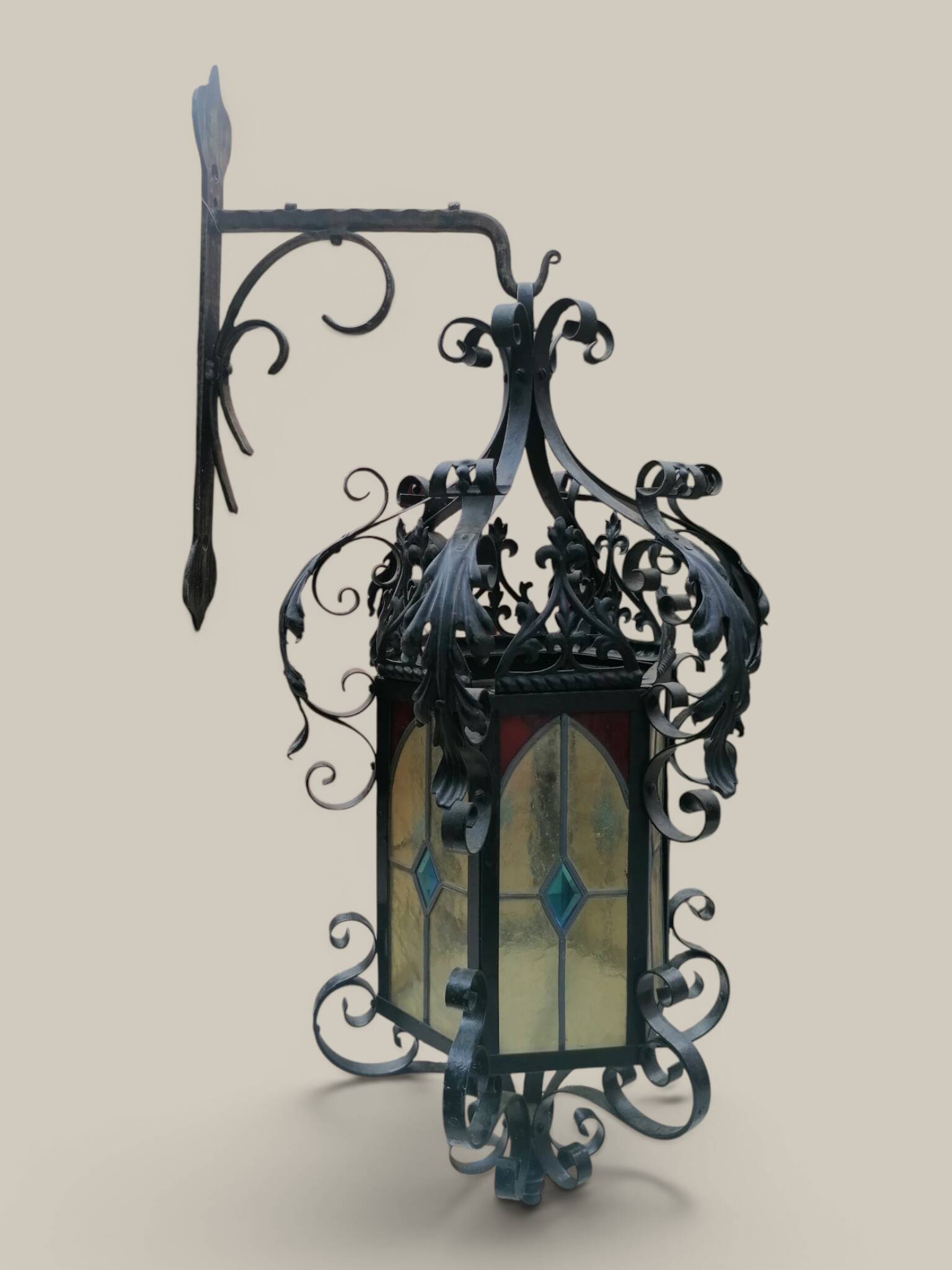 Black wrought iron lantern with stained glass. Medieval, Gothic decoration.