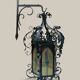 Black wrought iron lantern with stained glass. Medieval, Gothic decoration.