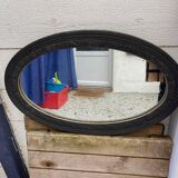 Old oval mirror with slate-coloured patina