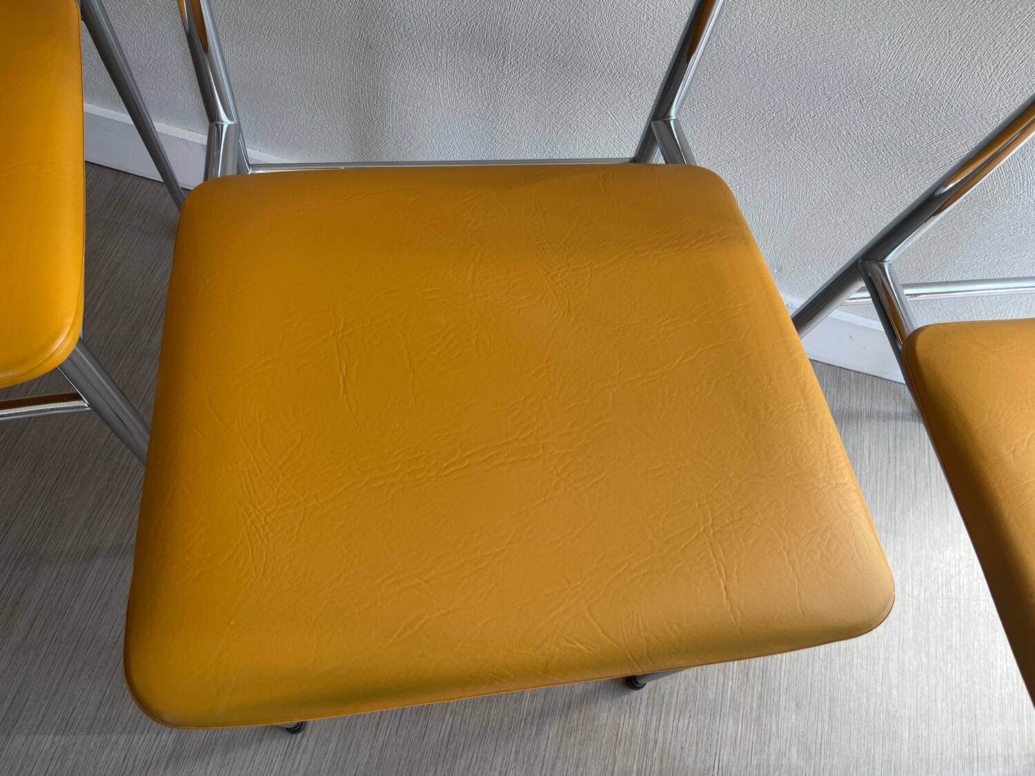 LM vintage chrome and orange/mustard yellow faux leather chairs