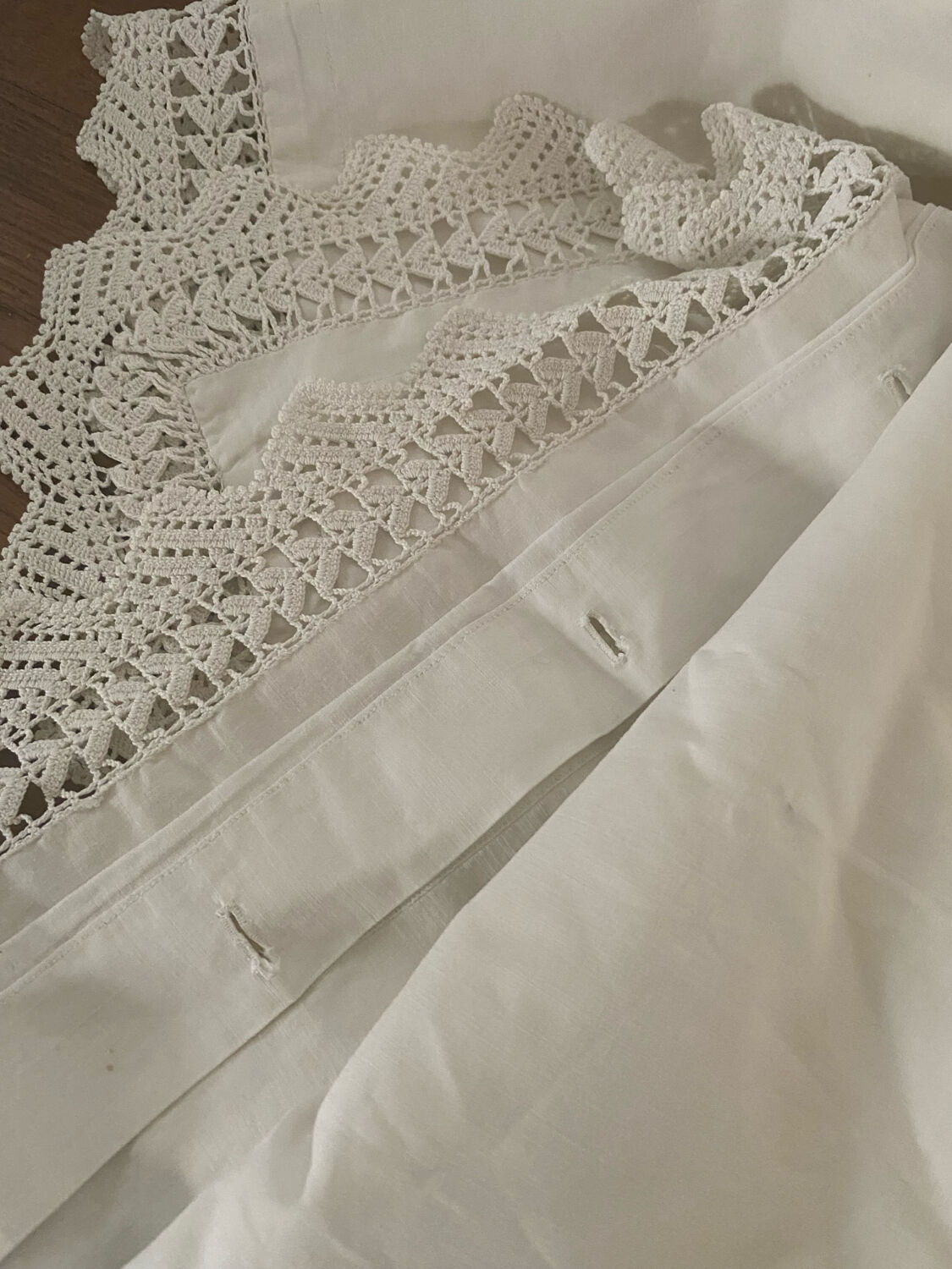 Antique white cotton pillowcase with crochet and monogram.
