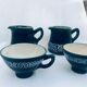 Two cups and two quimper milk jars