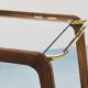 May include: A mid-century modern bar cart with a dark wood frame and two c