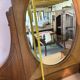 Antique carved wooden dressing table with marble and tilting oval mirror.