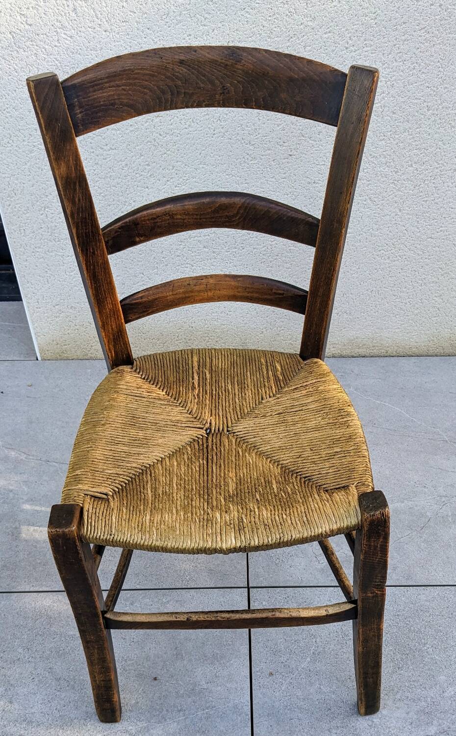 4 mismatched wood and straw chairs