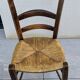 4 mismatched wood and straw chairs