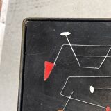 Black metal server and earthenware tiles with geometric patterns