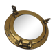 Mirror integrated into a brass navy porthole