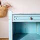 Small vintage bedside table in azure blue patina.