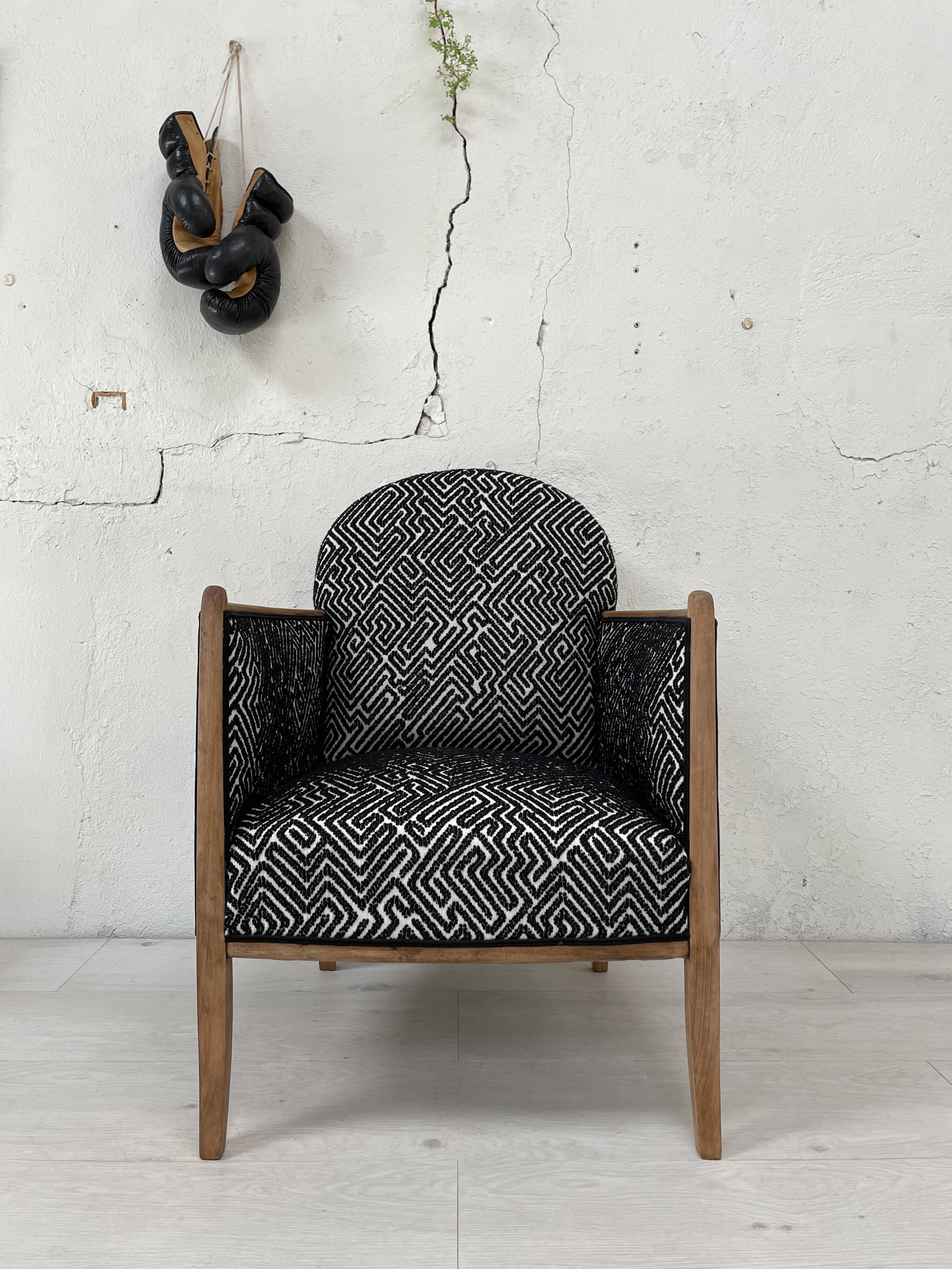 Club armchair in wood and fabric.