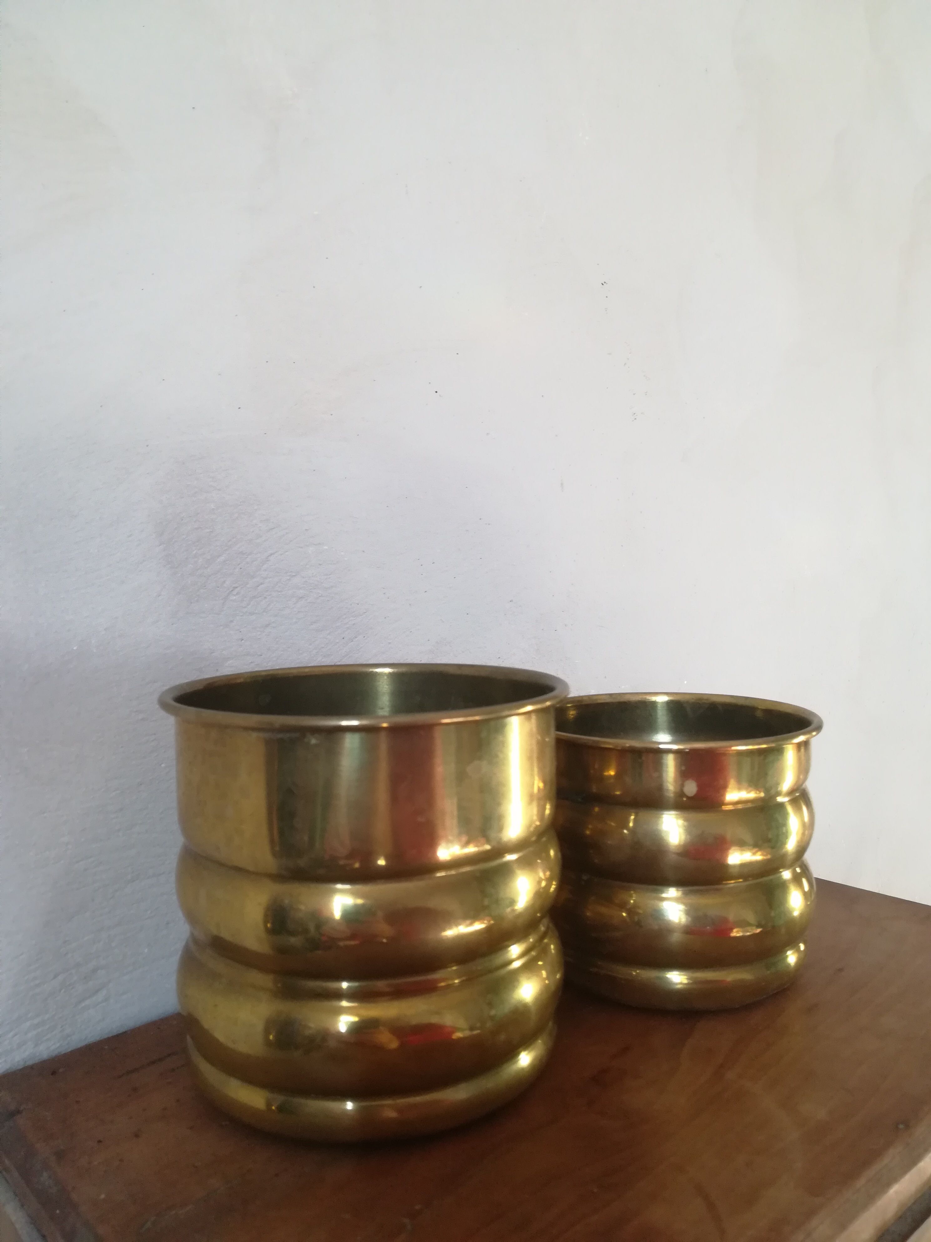 Duo of brass pot covers